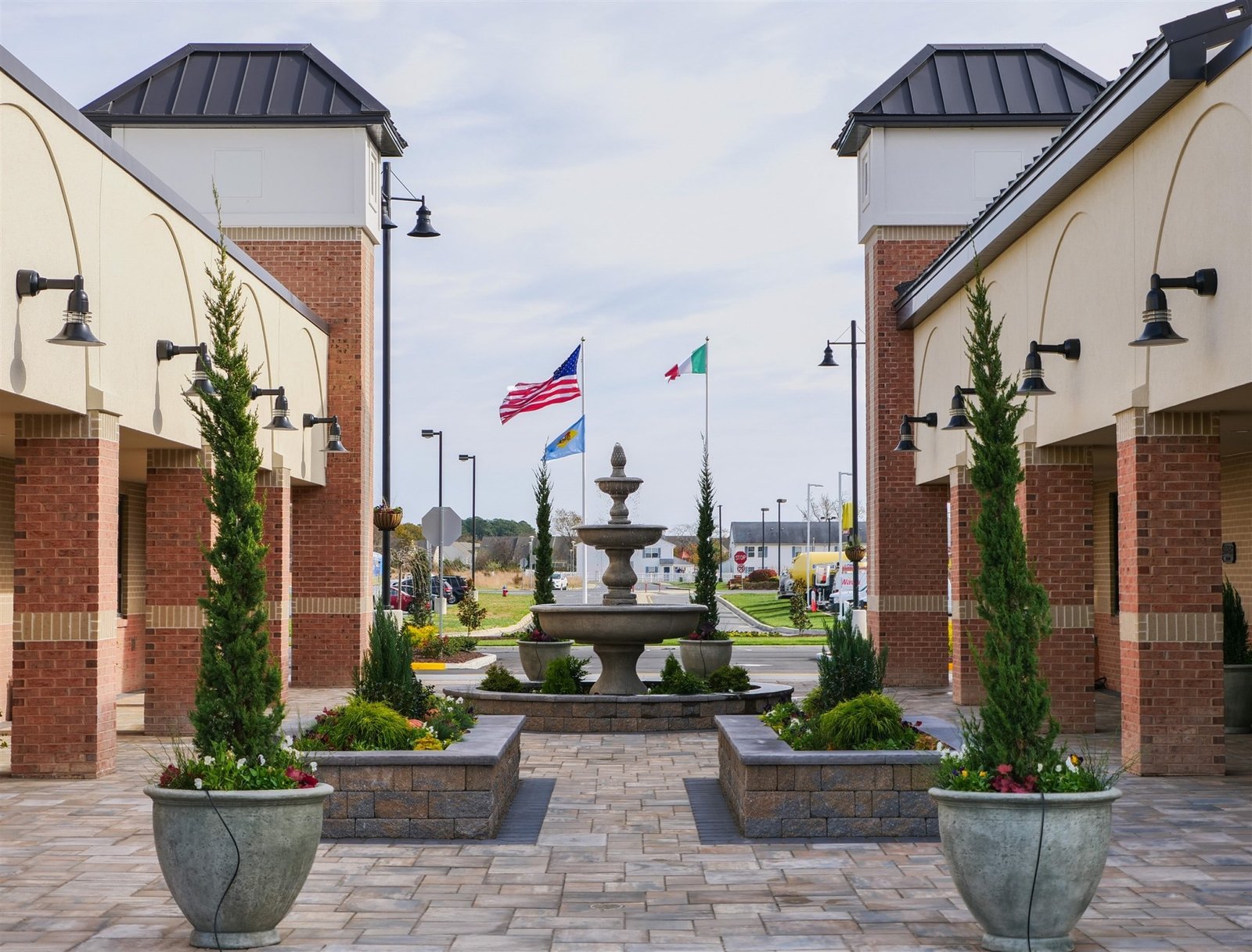 The courtyard at Taormina Square, Millsboro — flying the American, Delaware and Italian flags
